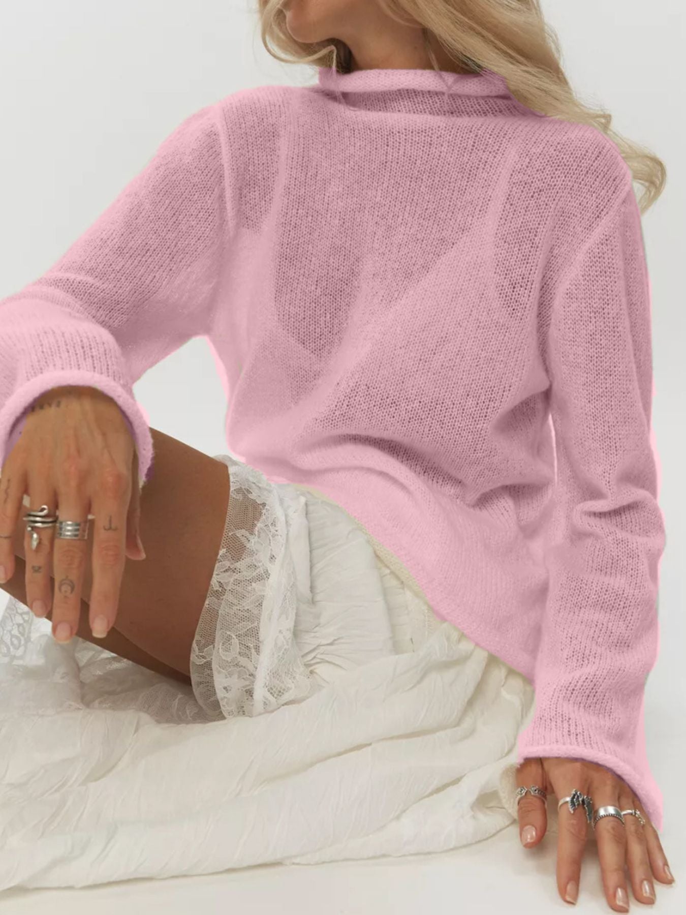 Mock Neck Long Sleeve Sweater in pink worn by a woman sitting, showcasing casual style and elegance.