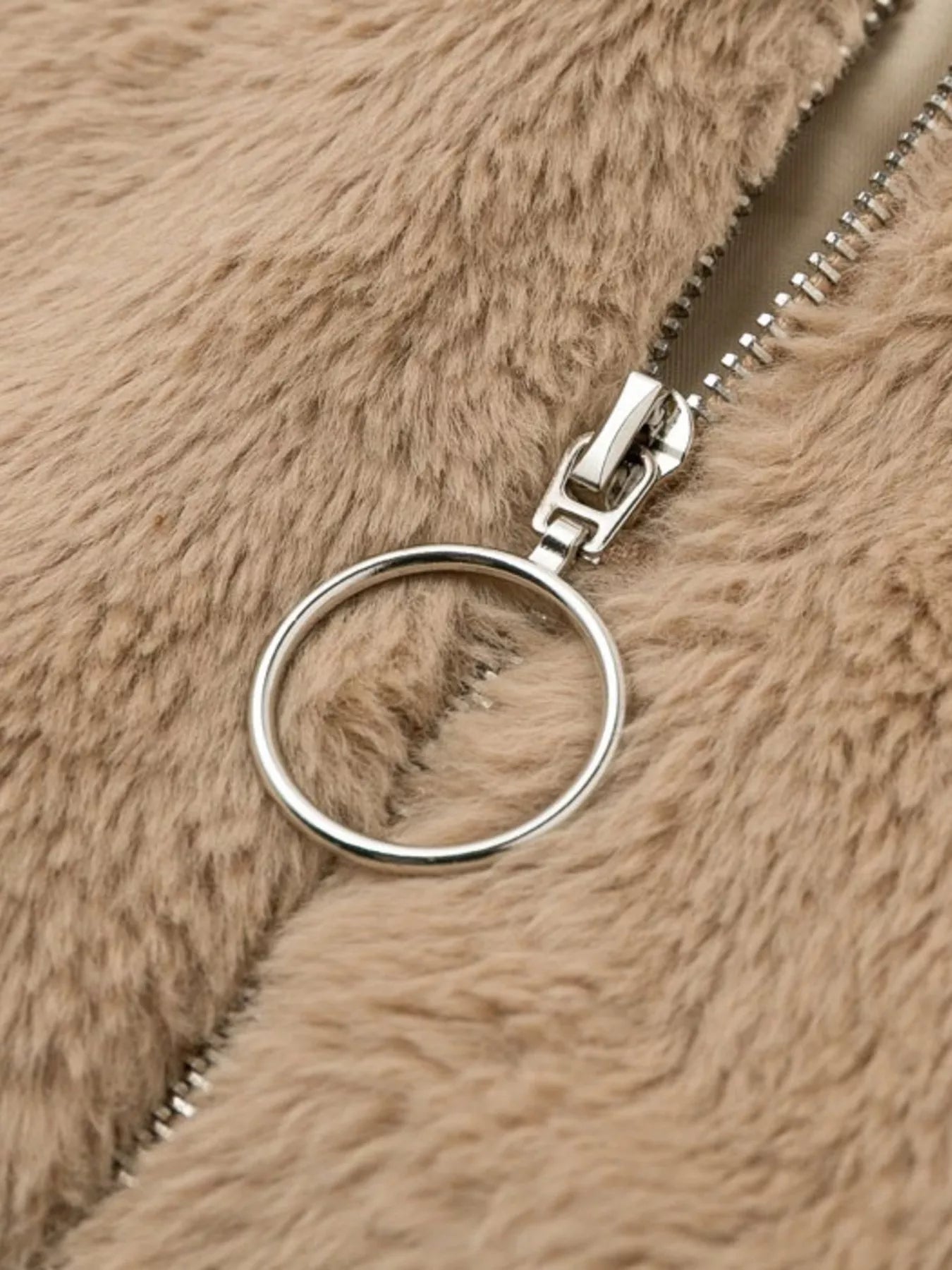 Close-up of the zipper detail on a Faux Fur Cropped Zip-Up Jacket, showcasing soft texture and silver hardware.