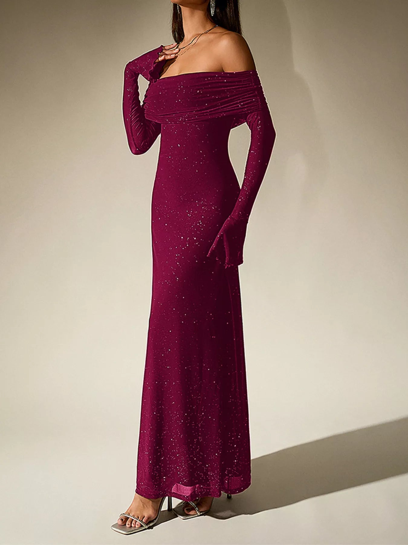 Glitter Off-Shoulder Maxi Dress in burgundy, featuring long sleeves and a form-fitting silhouette with sparkling glitter details.
