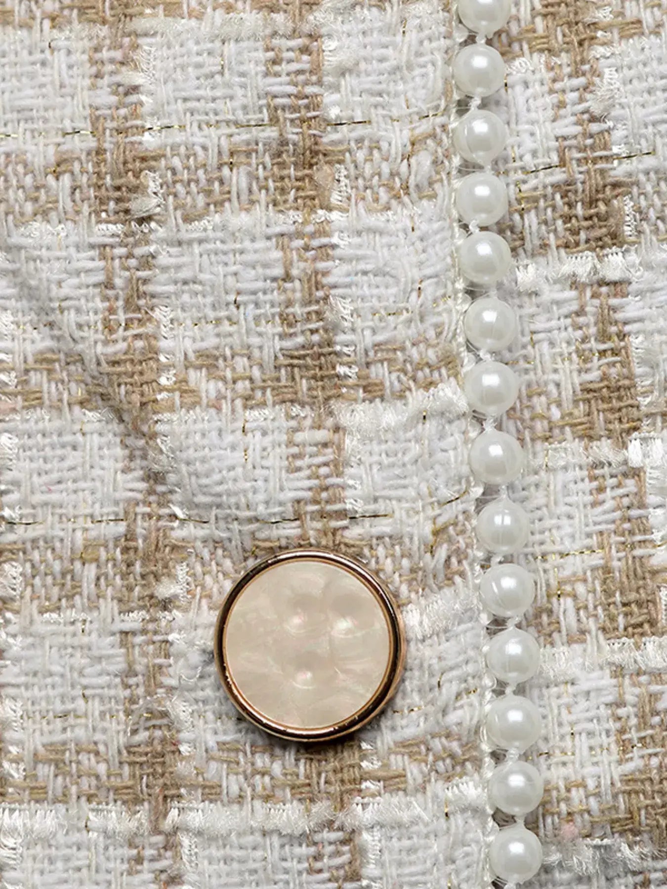 Close-up of the Plaid Button-Front Long Sleeve Outerwear showcasing its button and pearl details.