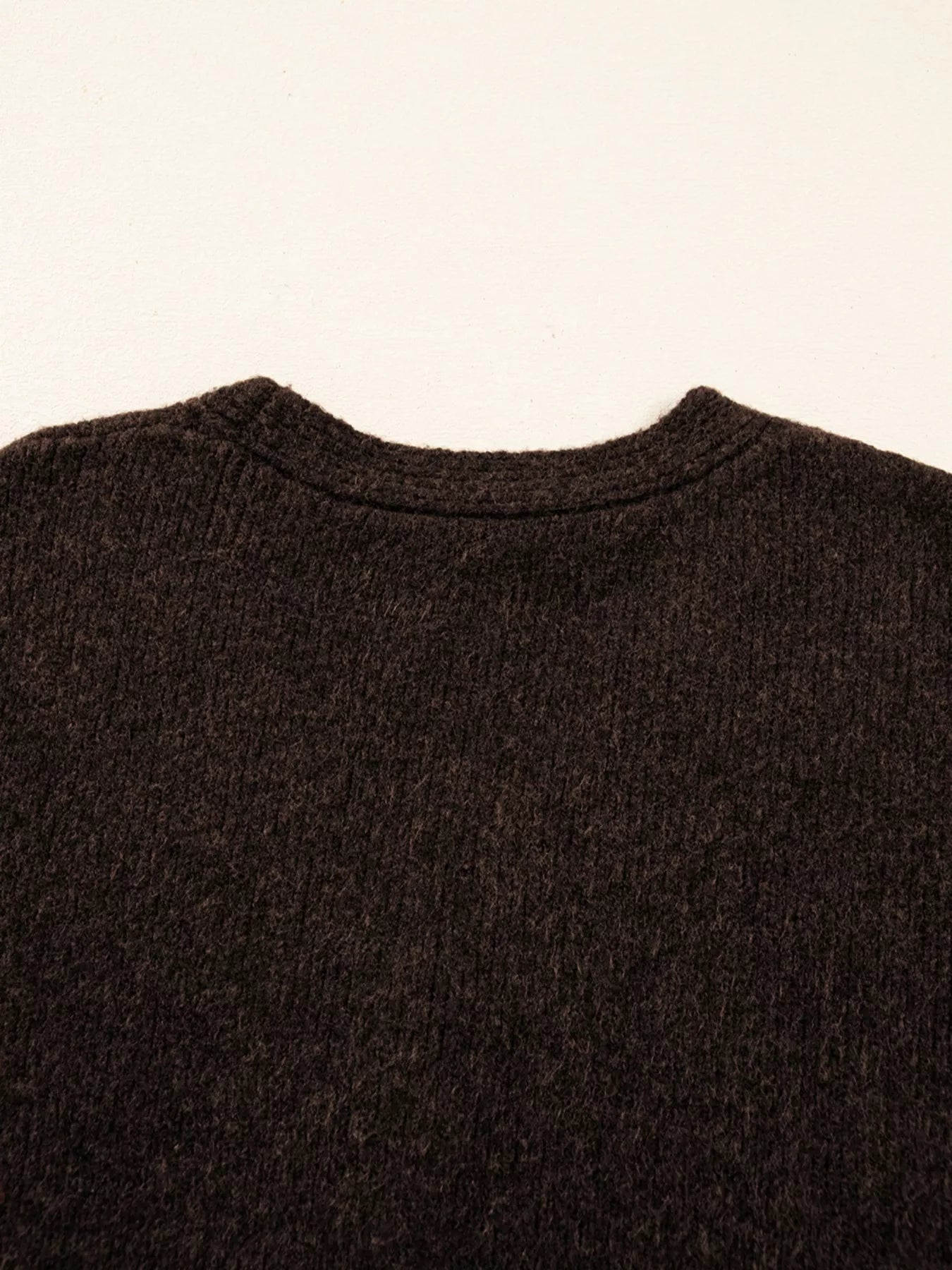 Back view of the Heart Metal Button V Neck Cardigan Sweater for Women showcasing its soft texture and stretchable material.