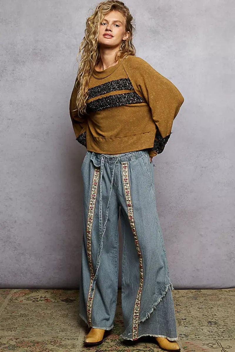 POL print patch round neck balloon sleeve cropped top styled with wide-leg jeans for a trendy look.