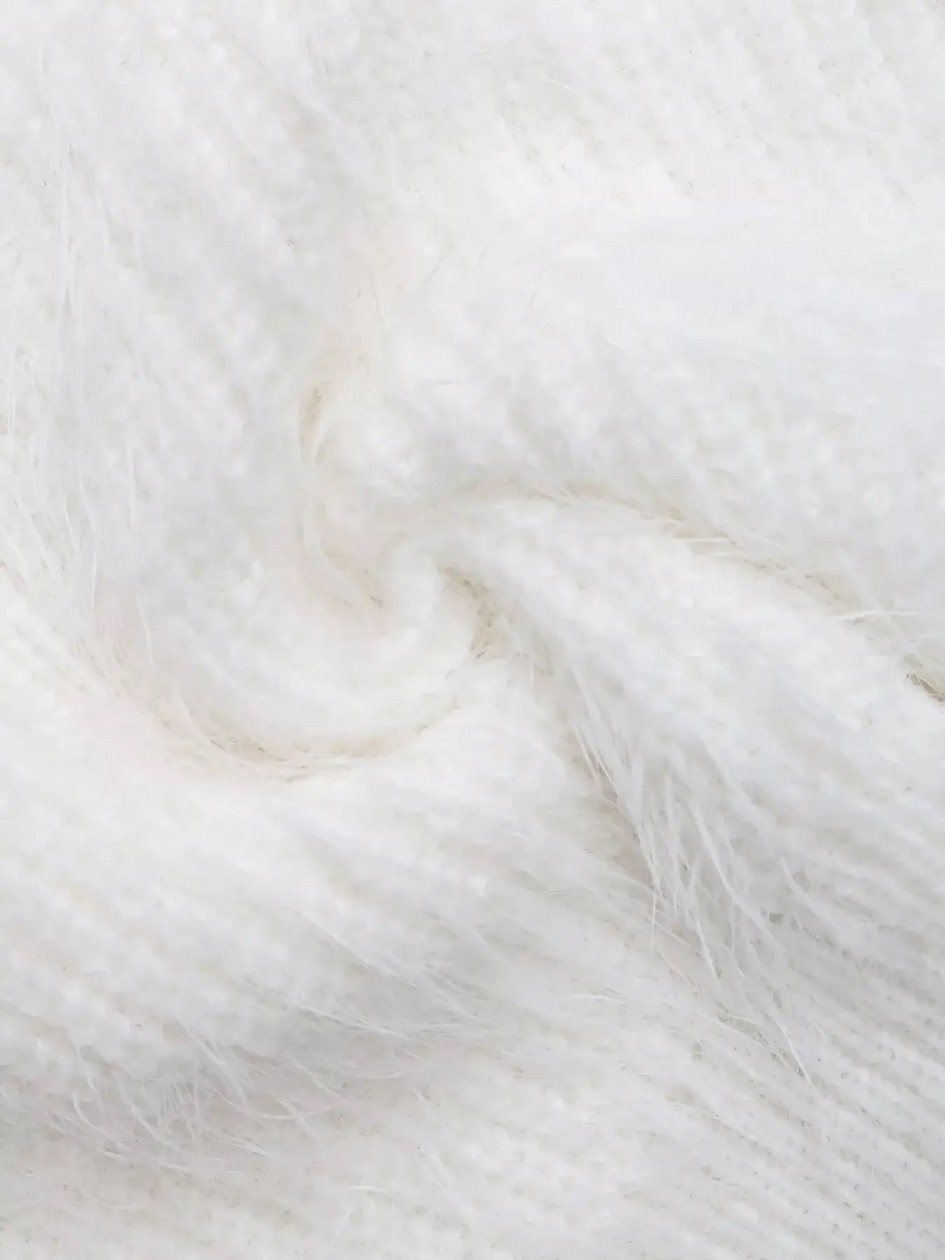 Textured white fabric swirl showcasing the soft and cozy feel of the Bow Scoop Neck Cropped Cami.
