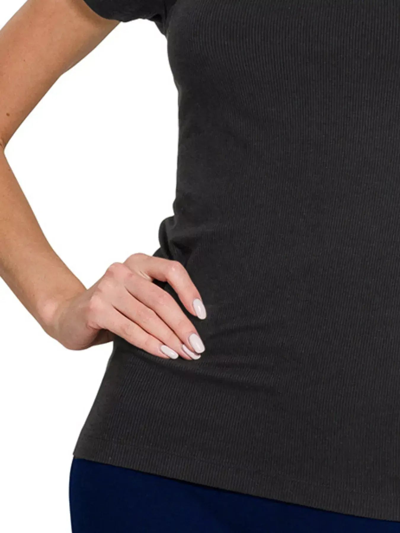 Close-up of a woman wearing a dark ribbed round neck t-shirt, showcasing a stylish and comfortable fit.