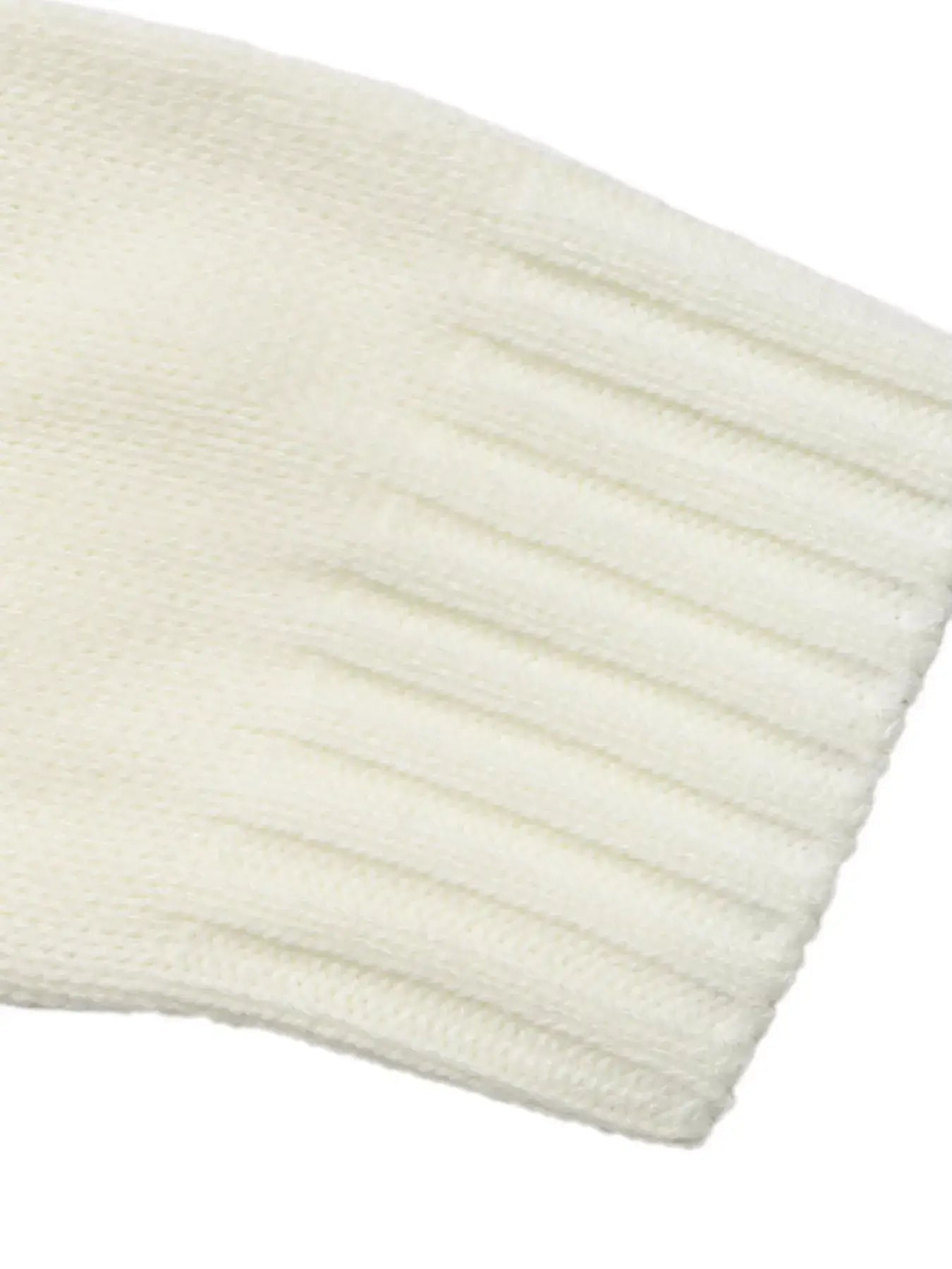 Detail of the ribbed cuff of the Fair Isle Pattern Crew Neck Sweater in soft white knit, showcasing comfort and elegance.