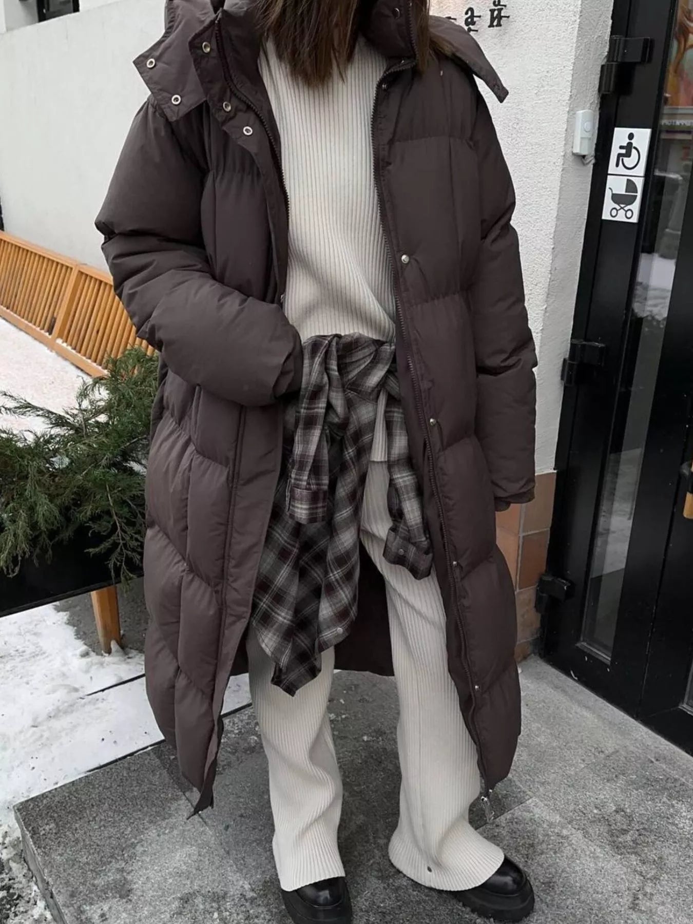 Longline Padded Winter Coat Belted worn by a woman, featuring a cozy and stylish design, perfect for cold weather.