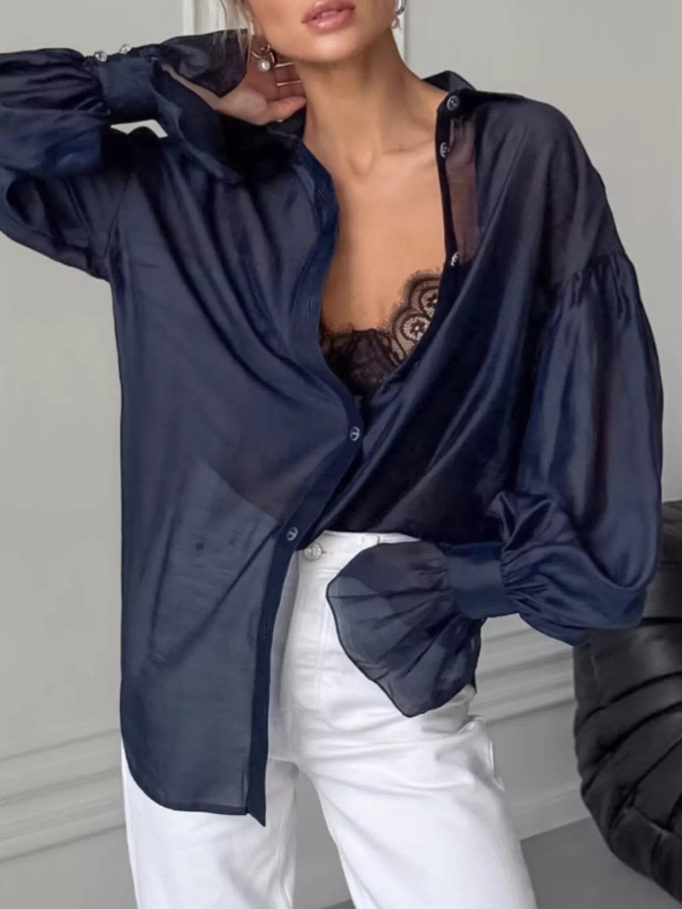 Button Up Flounce Sleeve Shirt in navy, styled with a lace top and white jeans for a chic, elegant look.