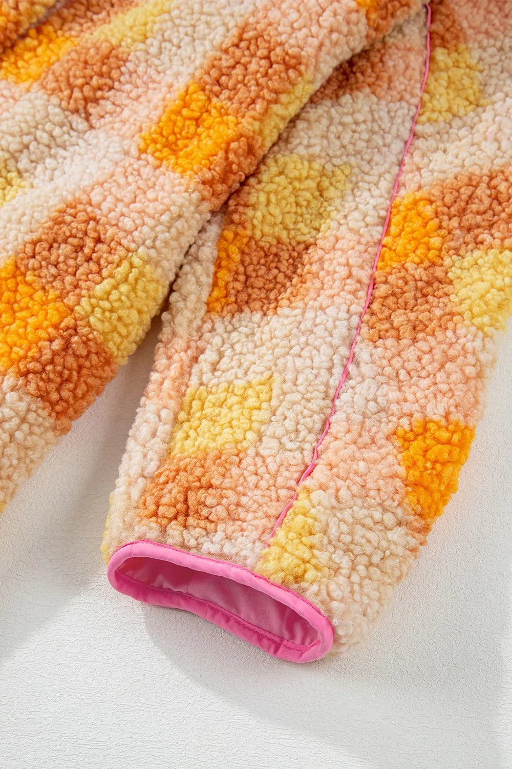 Checkered Long Sleeve Sherpa Hooded Jacket in vibrant orange, yellow, and pink hues, showcasing its cozy texture and lining.