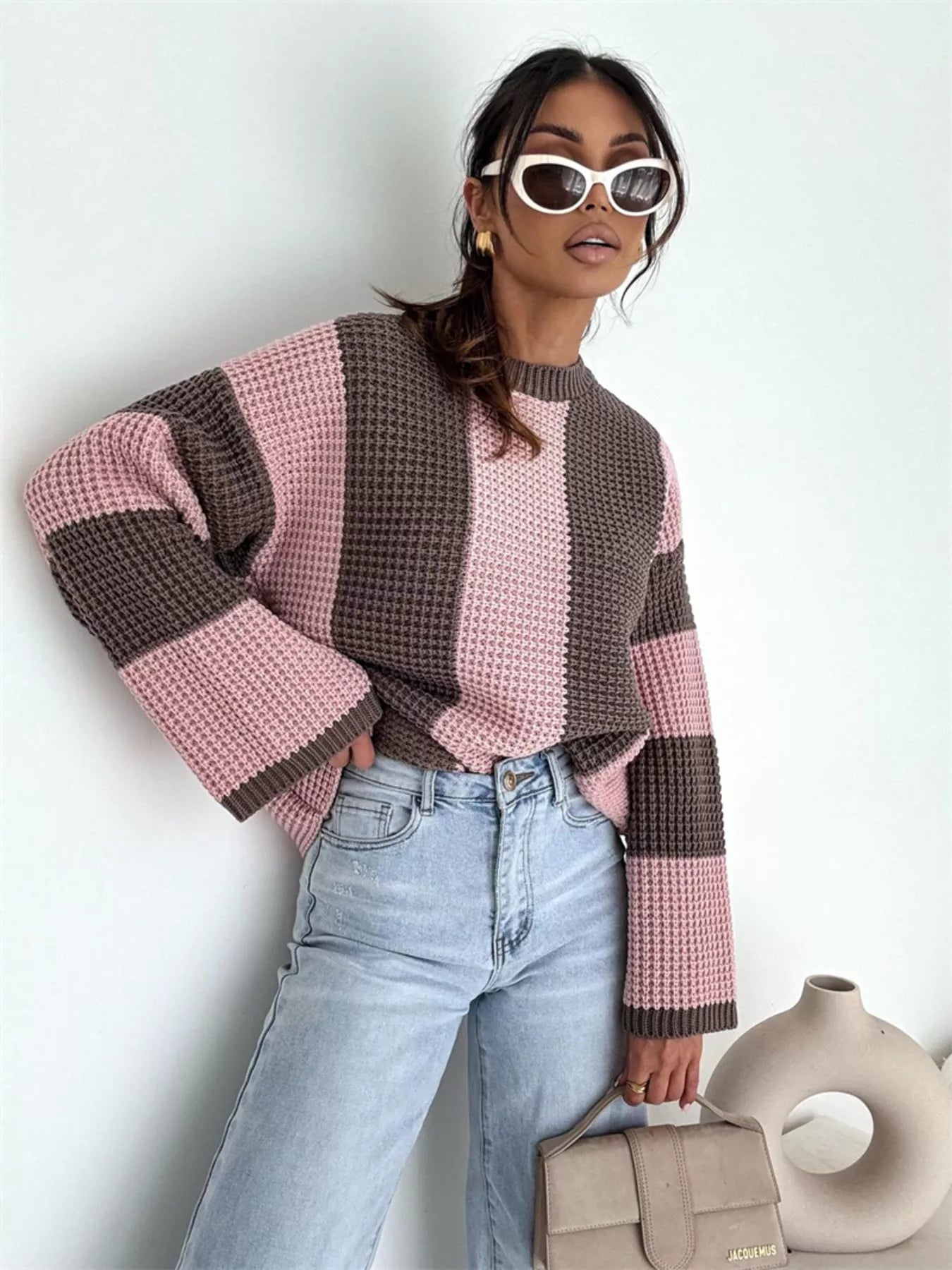 Model wearing Color Block Long Sleeve Sweater in pink and brown with oversized fit and sunglasses.