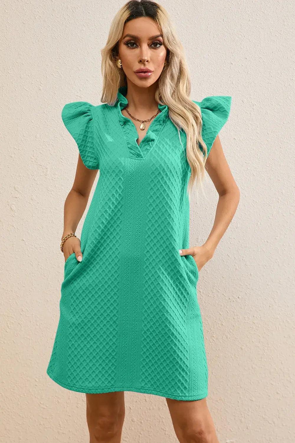 Ruffled V-Neck Cap Sleeve Mini Dress in green with pockets, ideal for a feminine everyday look.
