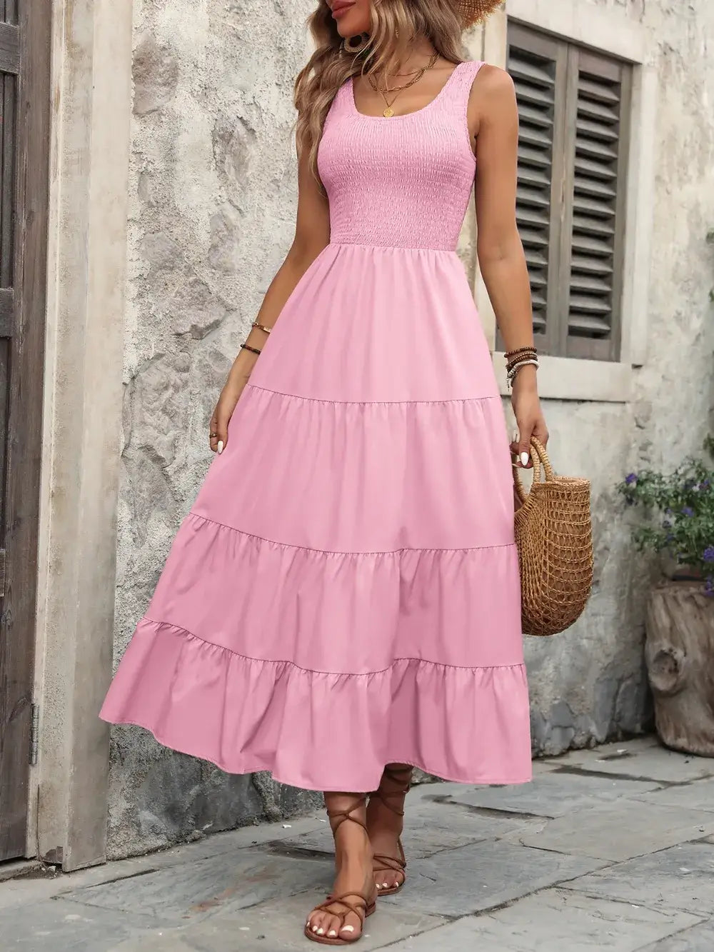 Ivy Lane pink smocked scoop neck sleeveless tank dress with tiered ruffles on a model outdoors.