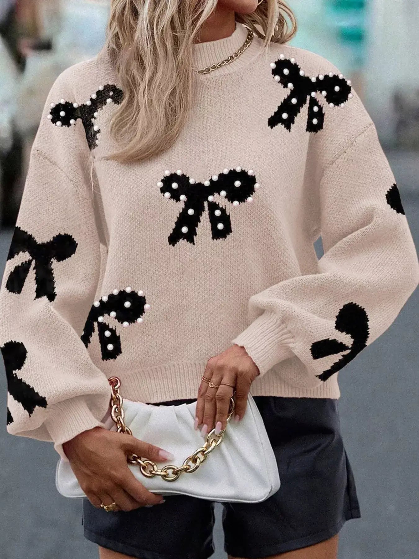Pearl embellished bow pattern loose sweater featuring bow designs and pearl accents, styled with relaxed fit.