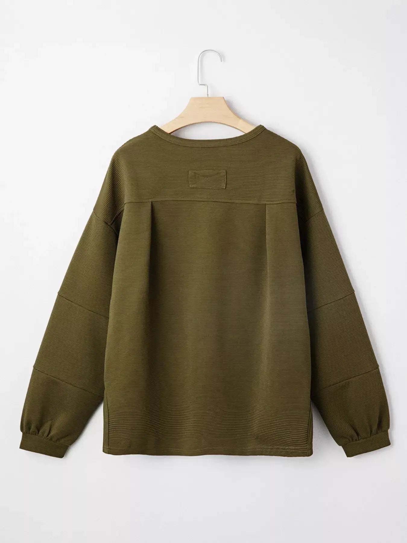 Back view of Ribbed Knit Oversized Sweatshirt in olive green on a hanger, showcasing its ribbed knit texture.