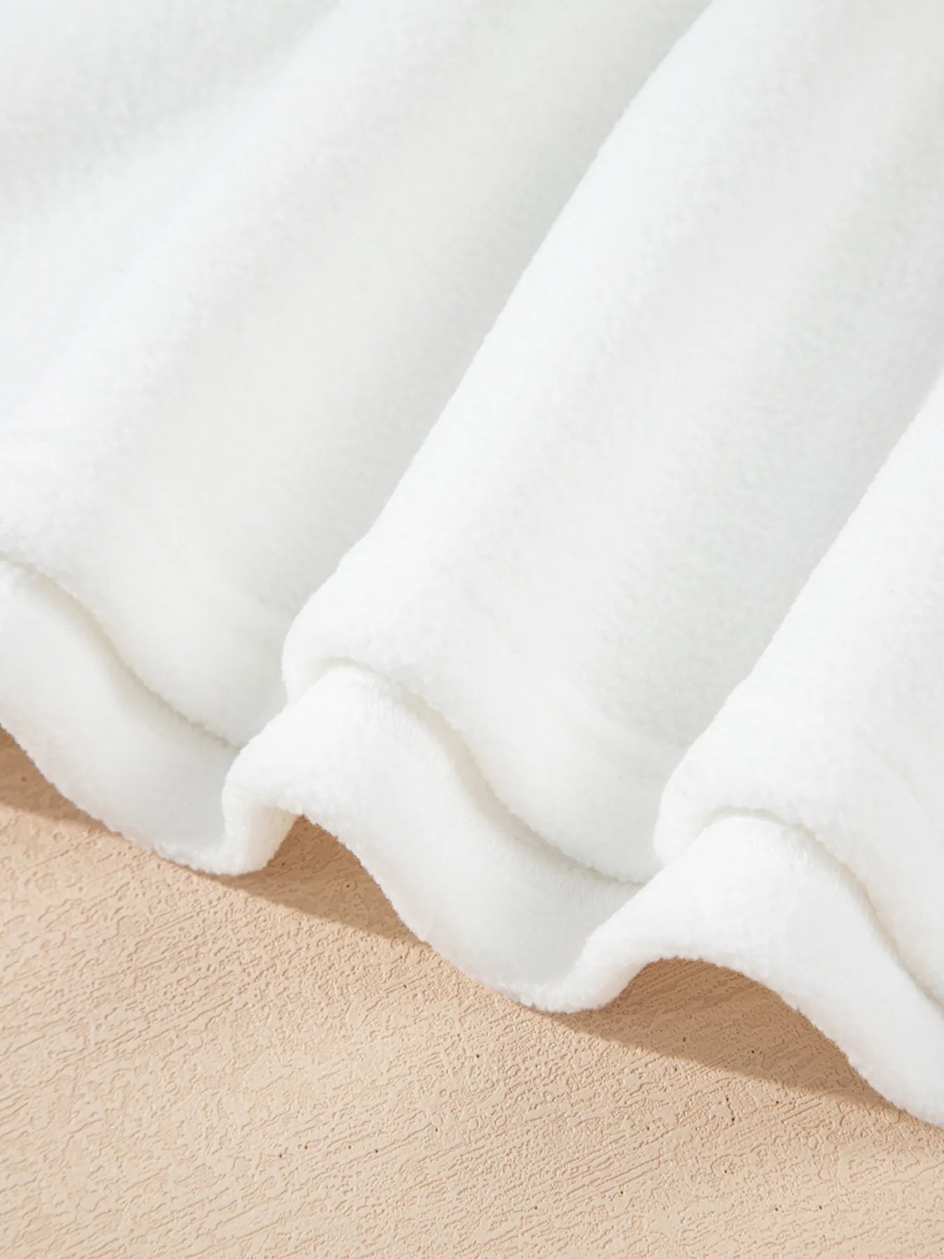 Exposed Seam Chest Pocket Knit Pullover Sweatshirt fabric texture in white, showcasing soft polyester material.