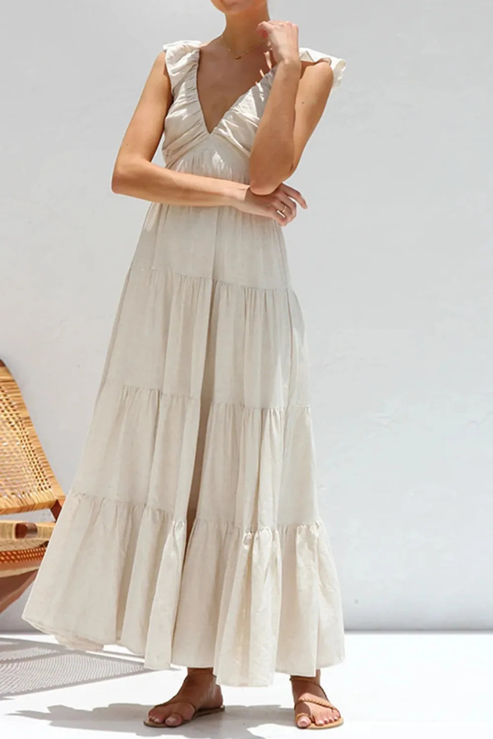 Ruffled V-Neck Tiered Dress in elegant smocked cotton style with ruffles and a flowing tiered design.