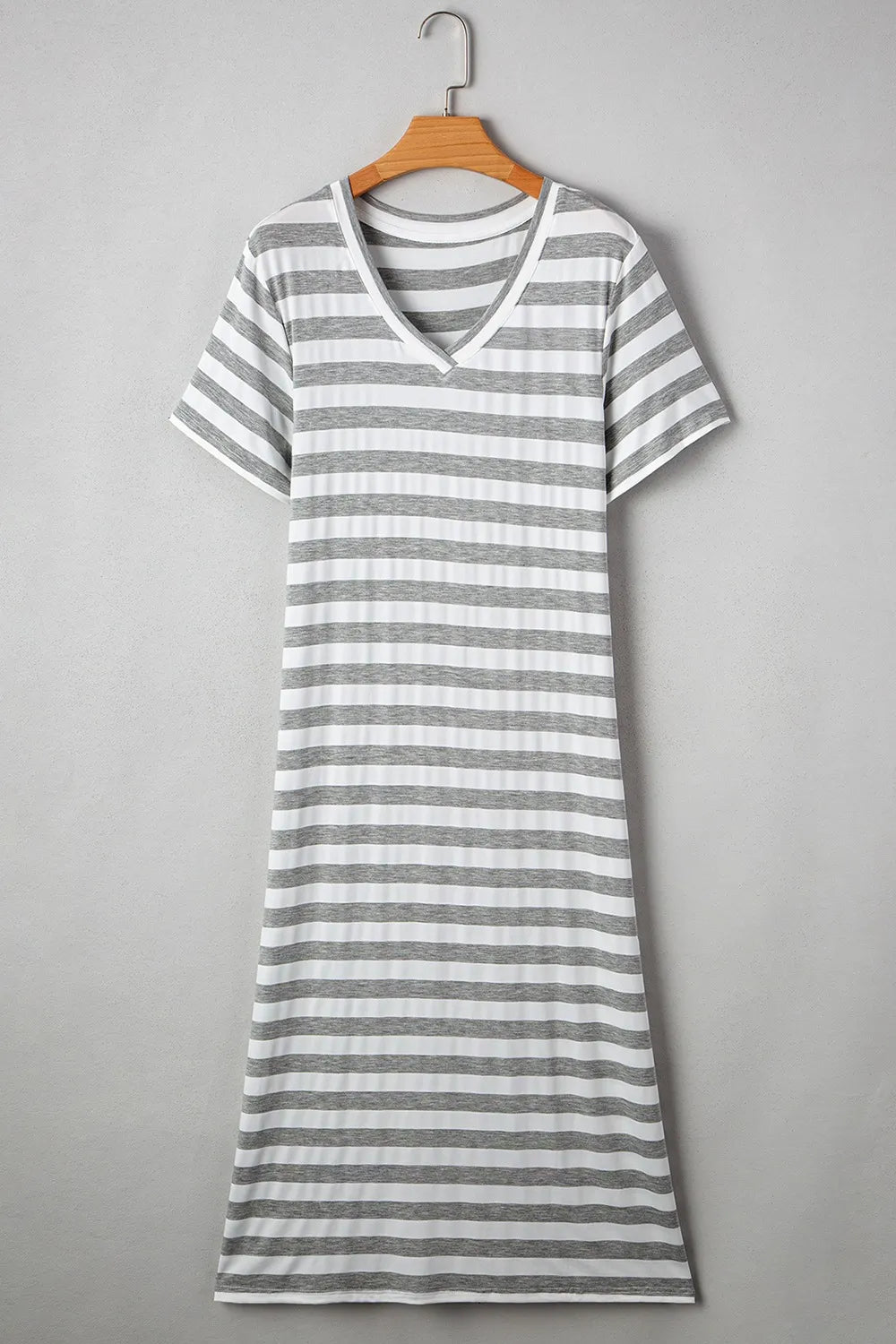 Casual Striped V-Neck Midi T-Shirt Dress hanging on a wooden hanger, showcasing its timeless striped design.