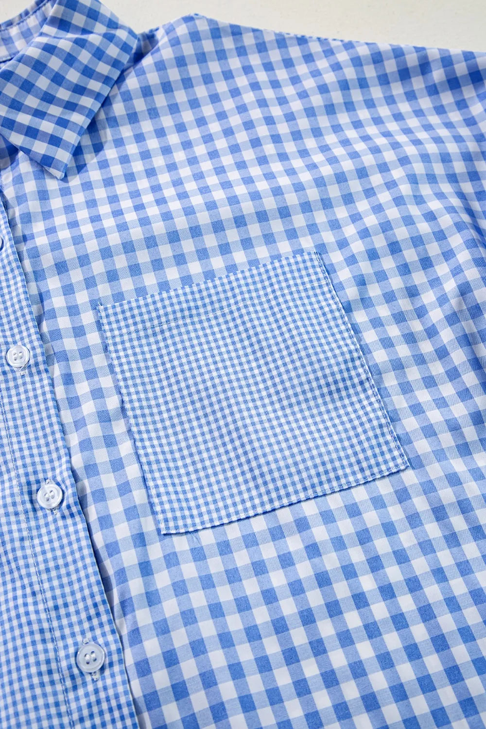 Plaid Button Up Long Sleeve Shirt featuring a front pocket and a blue checkered pattern.