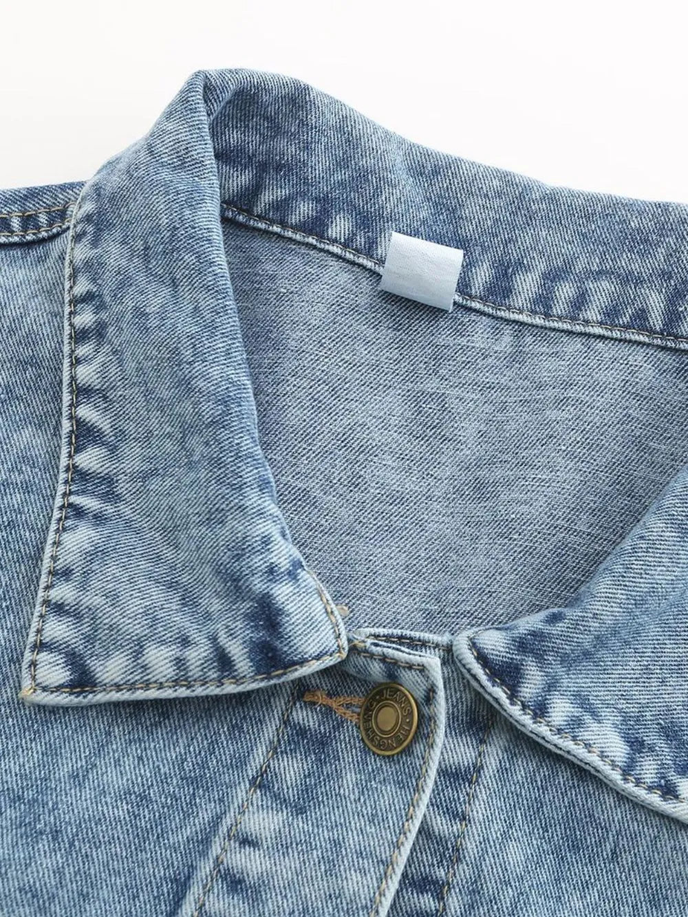 Close-up of the collar of a Button Down Drop Shoulder Denim Jacket for casual layering with blue denim texture.