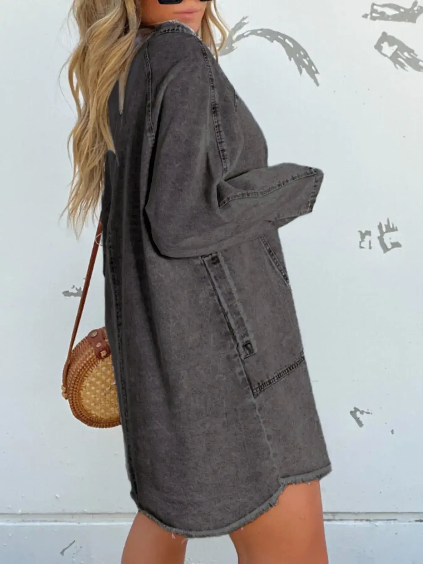 Model showcasing a full size long sleeve button-front denim dress in dark gray, styled with a round handbag.