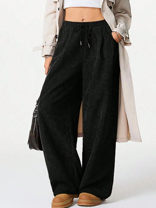 Woman wearing Drawstring Wide Leg Pants styled with a trench coat, showcasing comfort and relaxed fit.