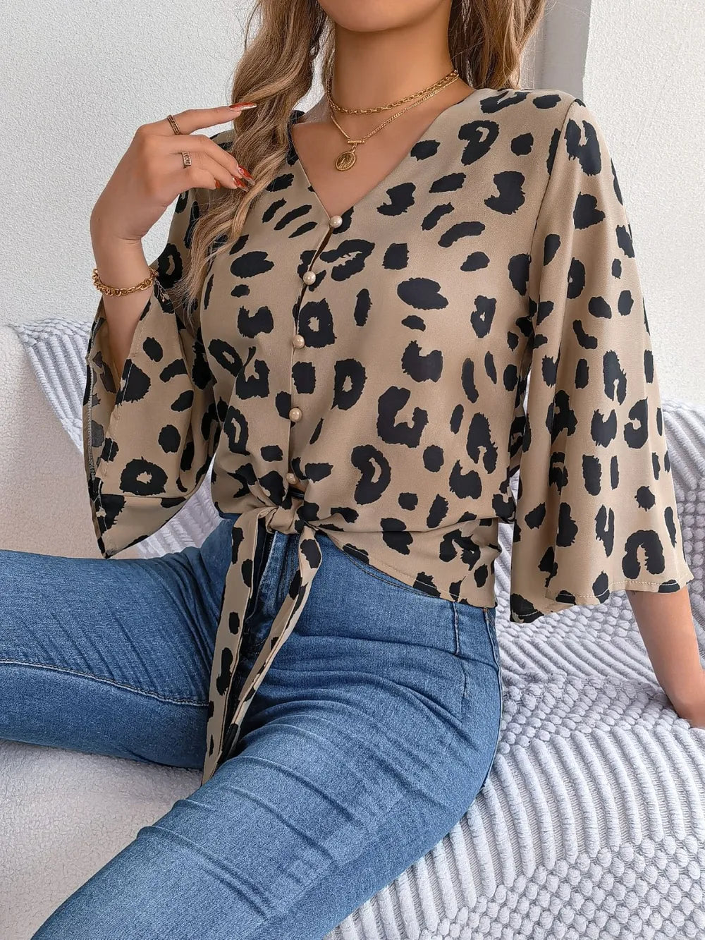 Tied Button Up Leopard V-Neck Blouse featuring a tied front, button details, and stylish leopard print pattern.