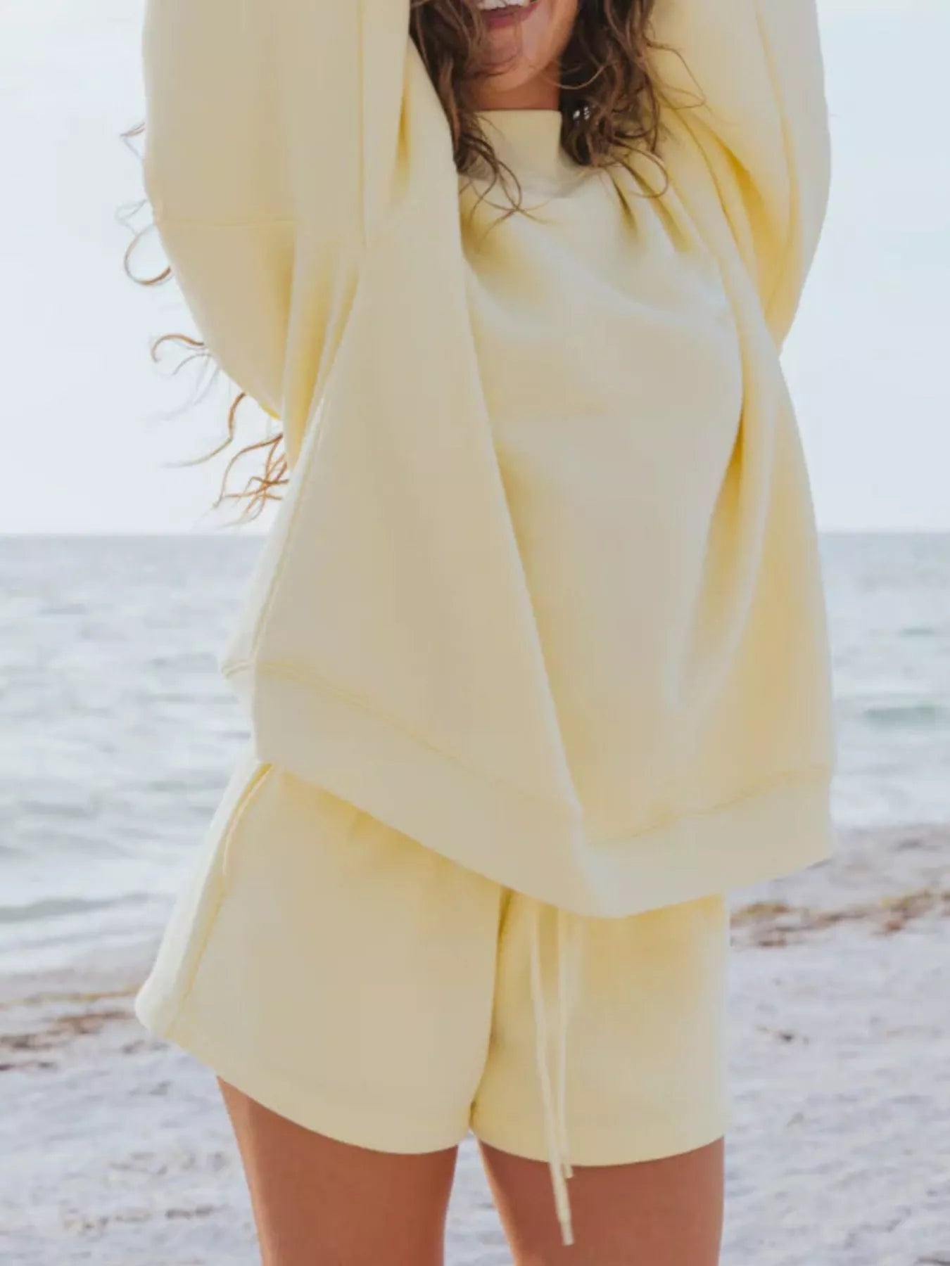 Relaxed Fit Round Neck Sweatshirt and Shorts Set in yellow, showcasing a casual and comfortable beach look.