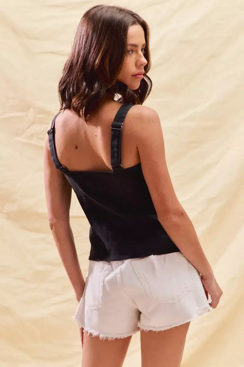 Back view of a woman wearing a fitted denim top with adjustable straps and white shorts, perfect for casual outings.