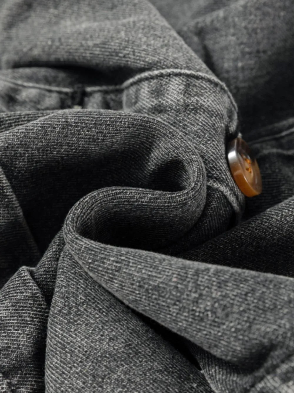 Close-up of fabric and button detail on the Wide Strap Button Down Denim Overall Dress, showcasing texture and quality.