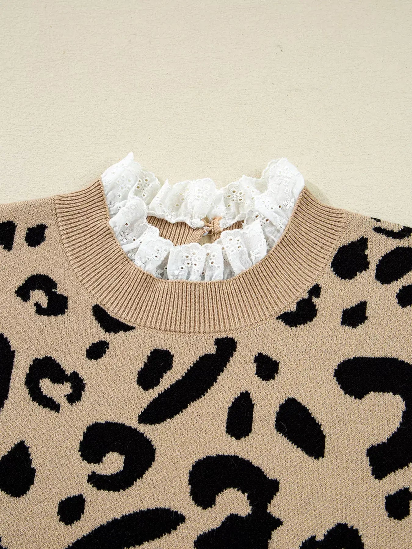 Leopard Pattern Lace Ribbed Detail Button Top with a chic ruffled neckline and bold leopard print design.