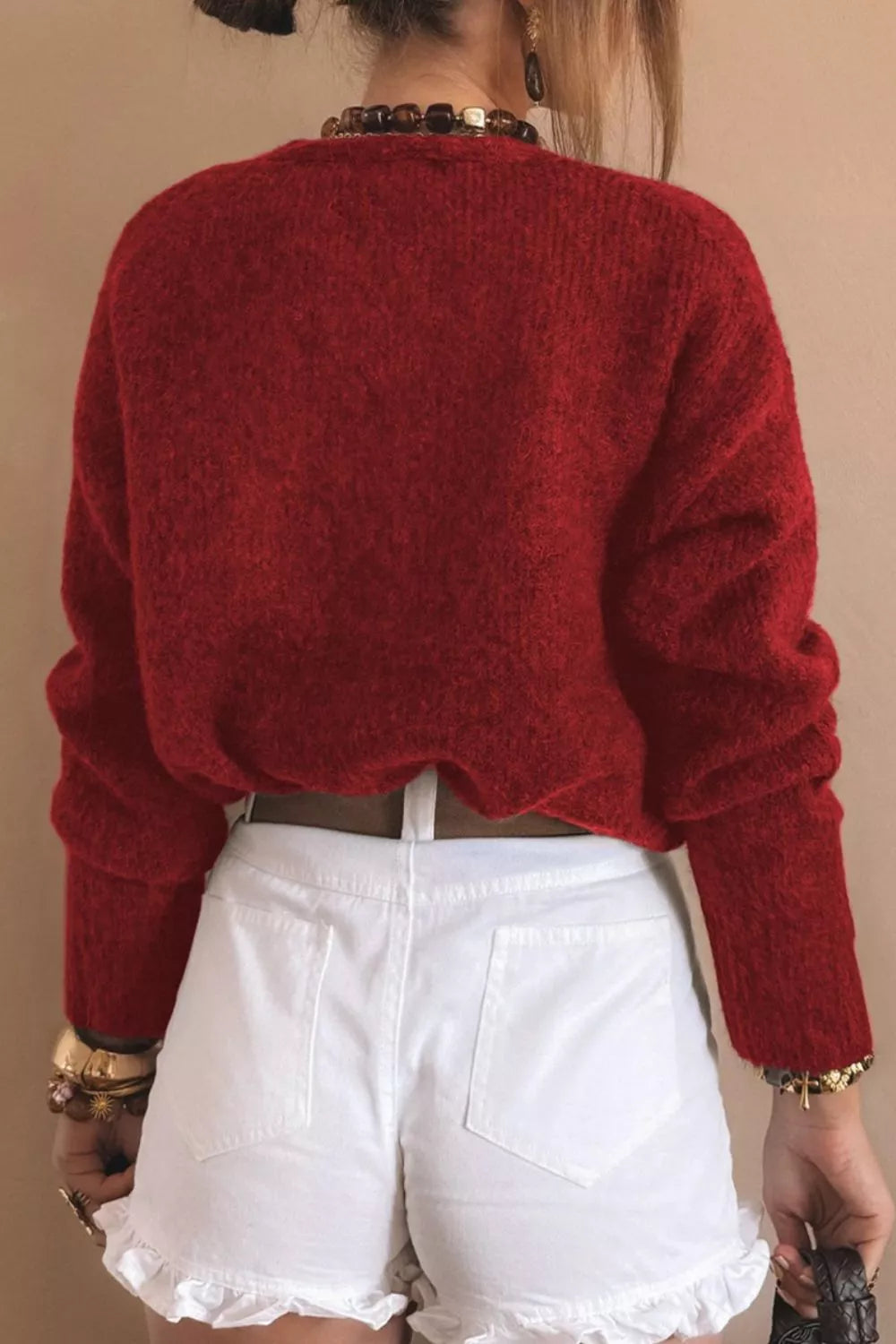 Back view of Heart Button Fuzzy Knit Cardigan in red, styled with white shorts, perfect for cozy everyday wear.