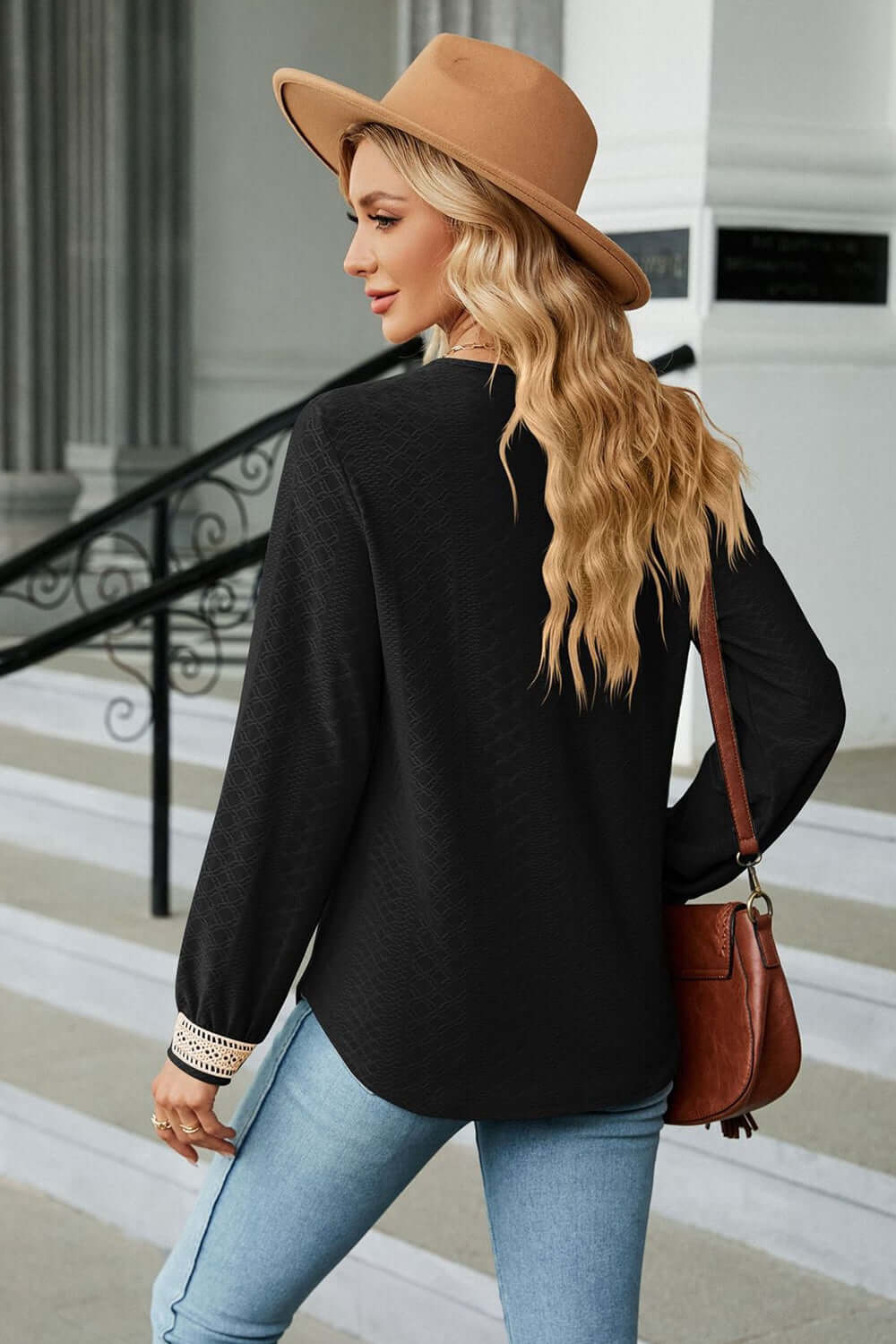 Woman wearing a V-Neck Long Sleeve Blouse with a hat, showcasing the elegant design and soft fabric.