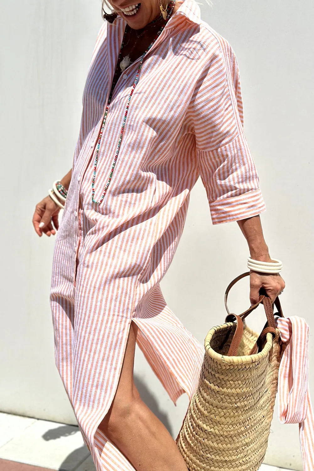 Tied Button Up Three-Quarter Sleeve Dress for Women in striped design, paired with a straw bag, perfect for summer outings.