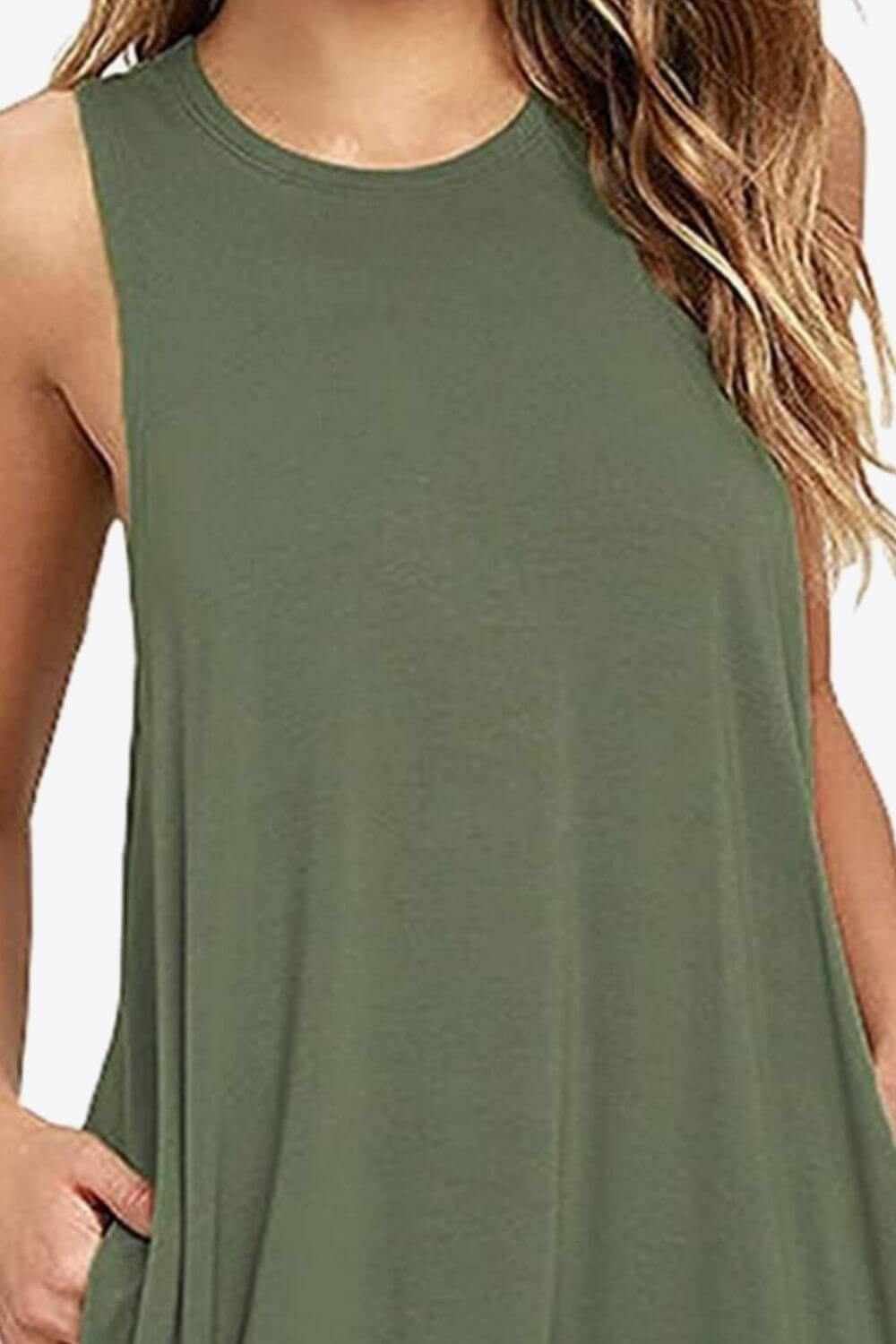 Close-up of a sleeveless green dress featuring a round neck and side pockets, perfect for casual wear.