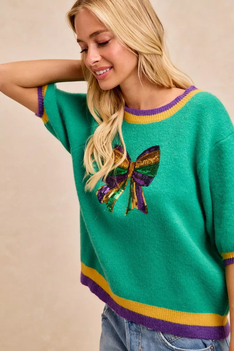 BiBi Mardi Gras Sequin Ribbon Patched Sweater featuring vibrant colors and sequin details for a festive look.