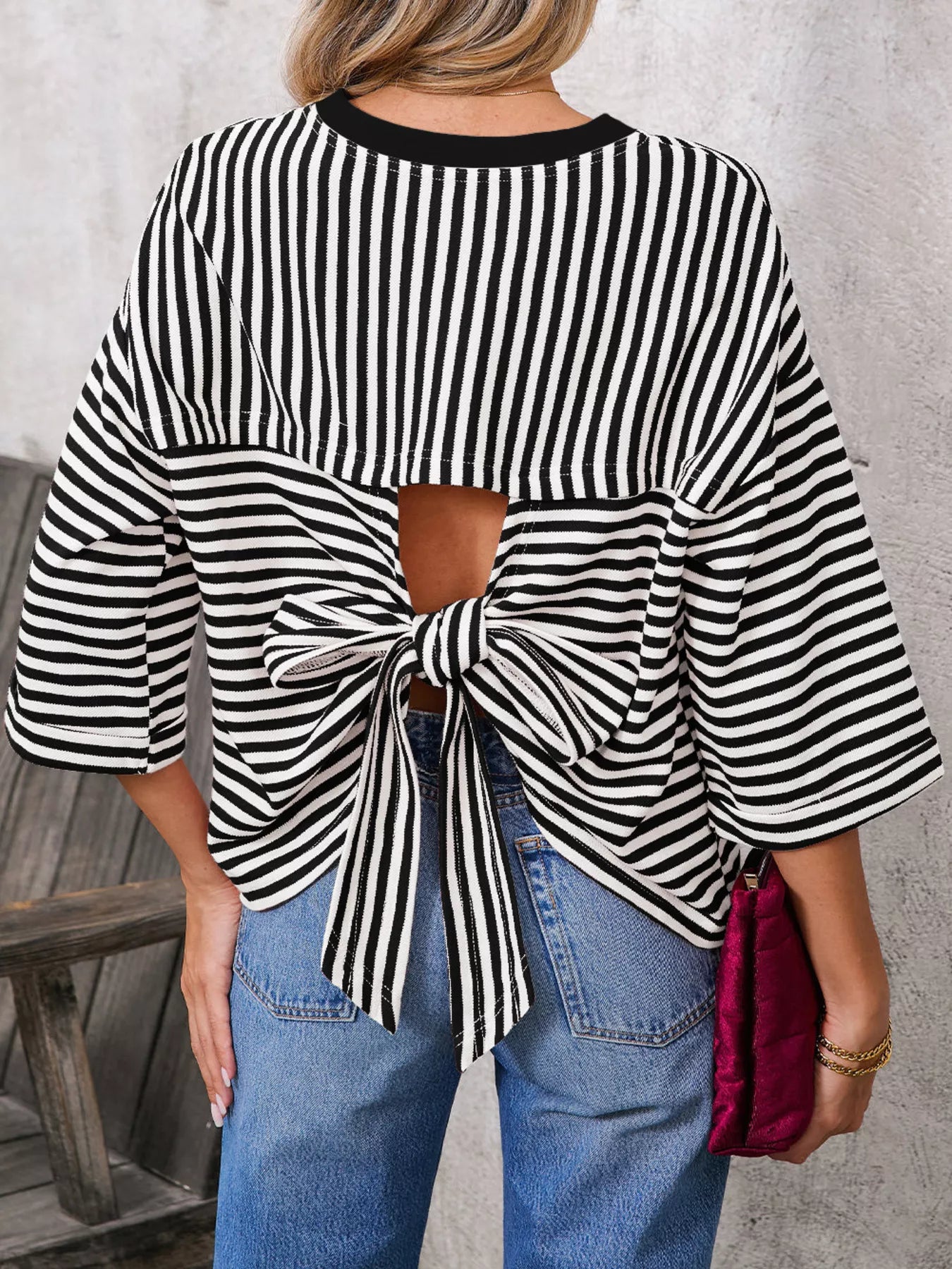 Striped Back Bow Tie T-Shirt showcasing oversized style with bow detail and black and white stripes.