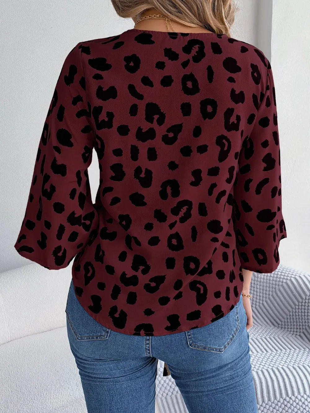Back view of Tied Button Up Leopard V-Neck Blouse in burgundy with black leopard print, featuring 3/4 sleeves.
