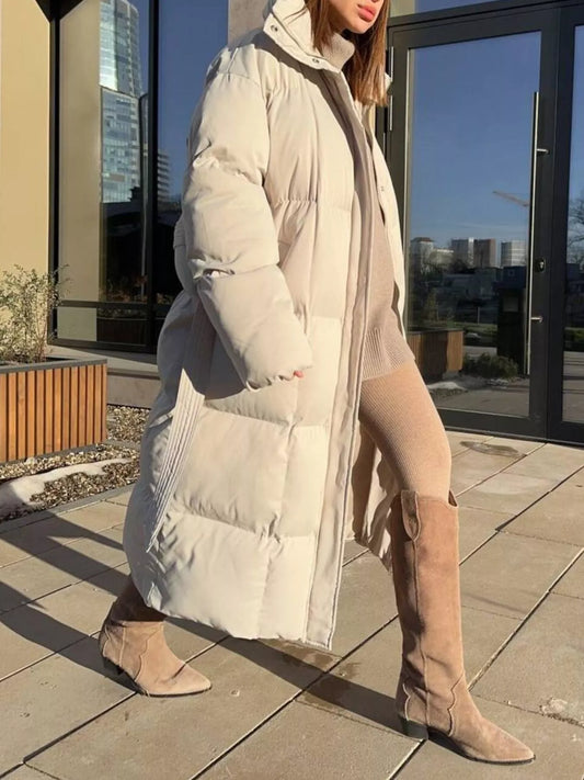 Longline Padded Winter Coat Belted worn by a woman in a stylish outdoor setting.