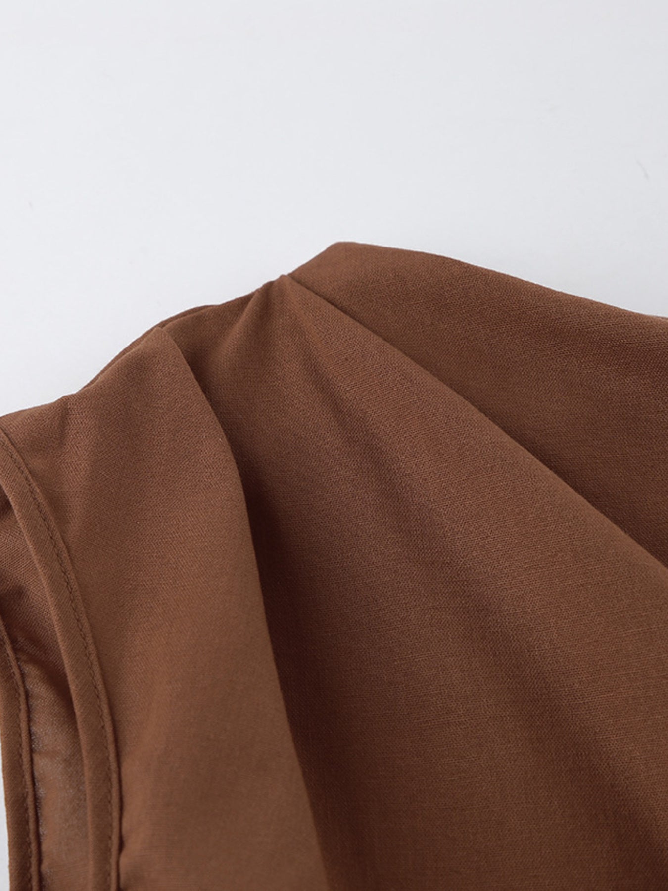One Shoulder Top and Shorts Set stylish asymmetrical outfit close-up of the brown fabric showing ruched details.