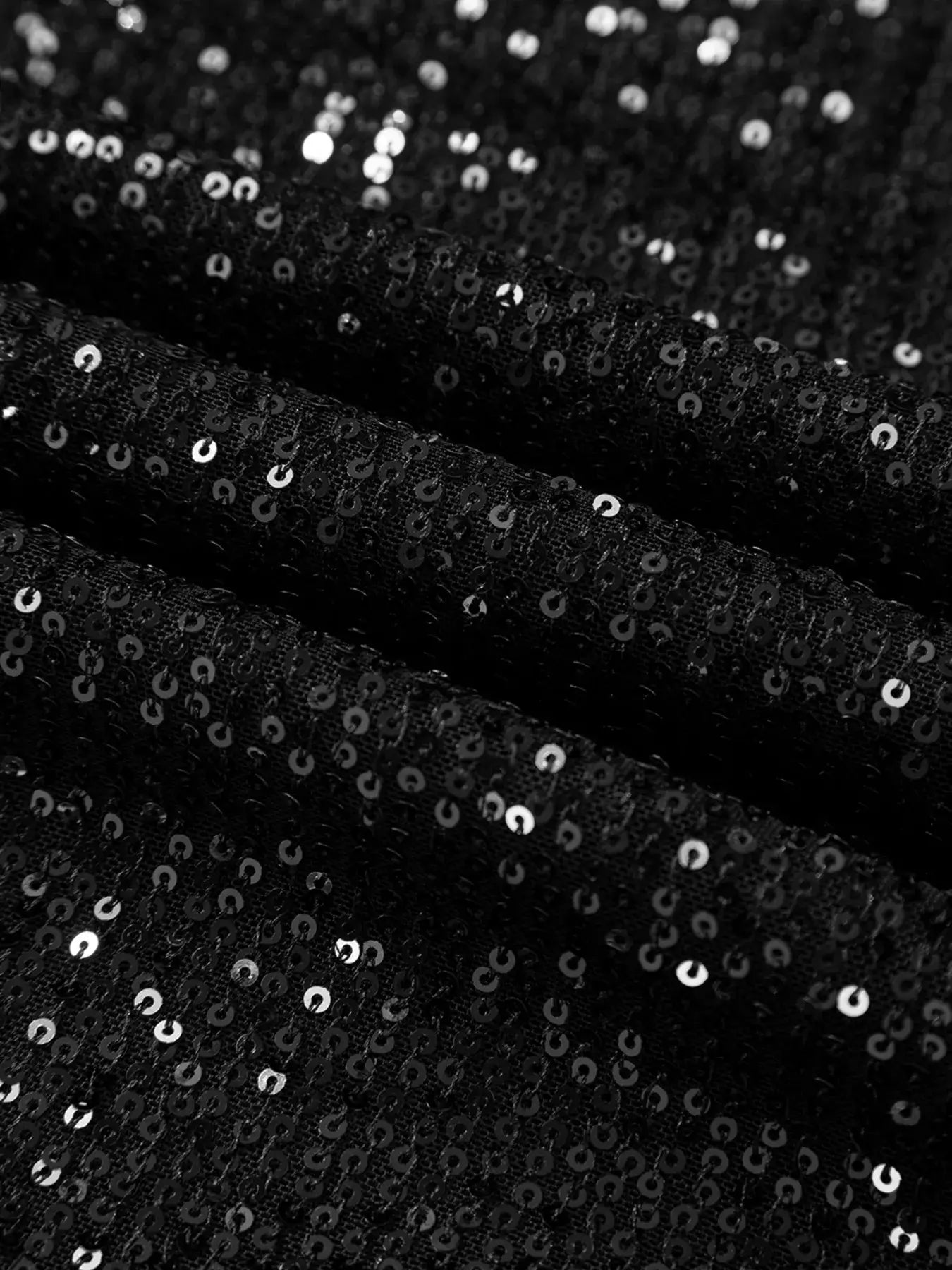 Close-up of shimmering fabric showcasing the sequins of the Sequin Mock Neck Drape Open Back Bell Sleeve Top.