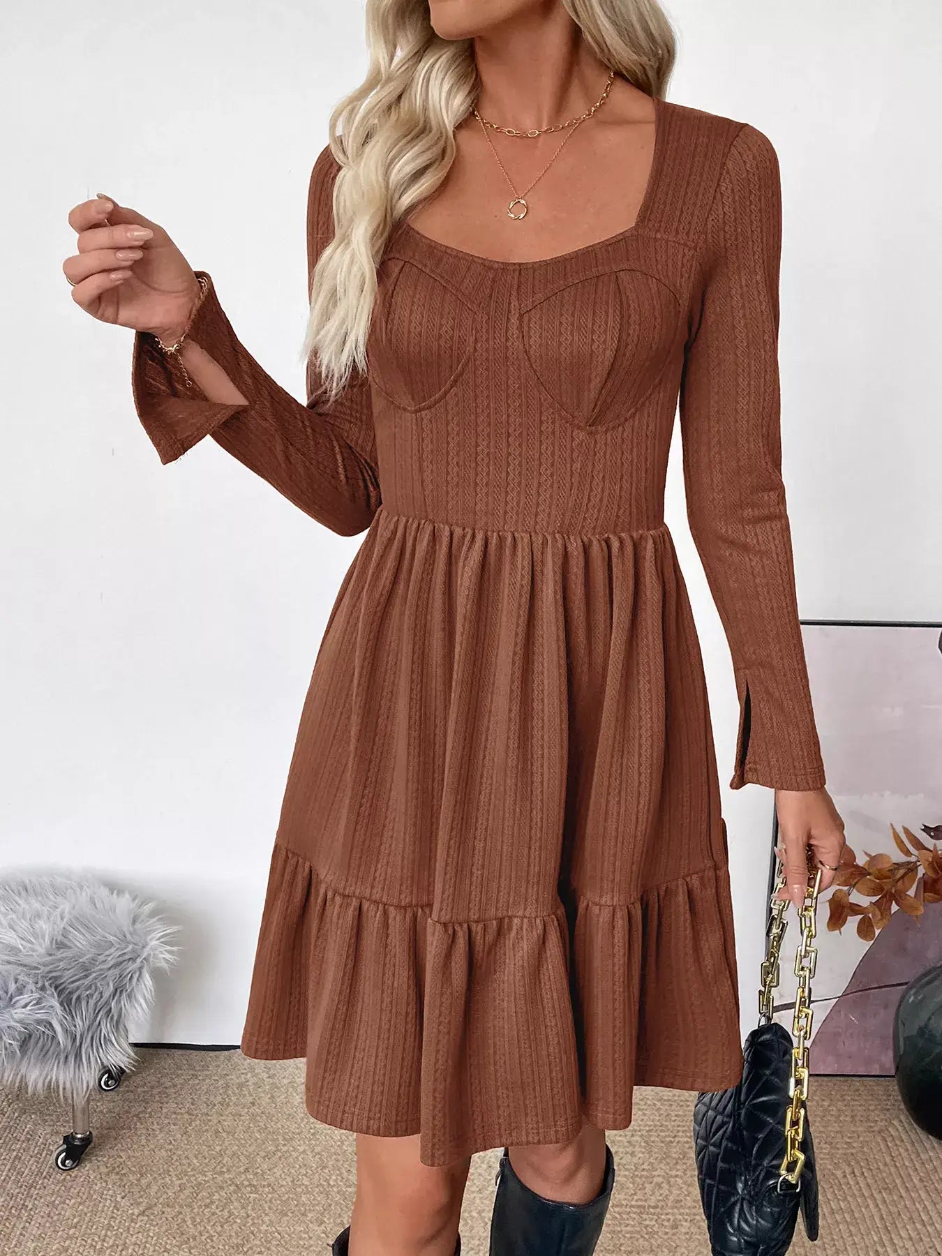 Woman in a brown Ruffled Hem Long Sleeve Knit Dress, showcasing a stylish design with ruffles and long sleeves.