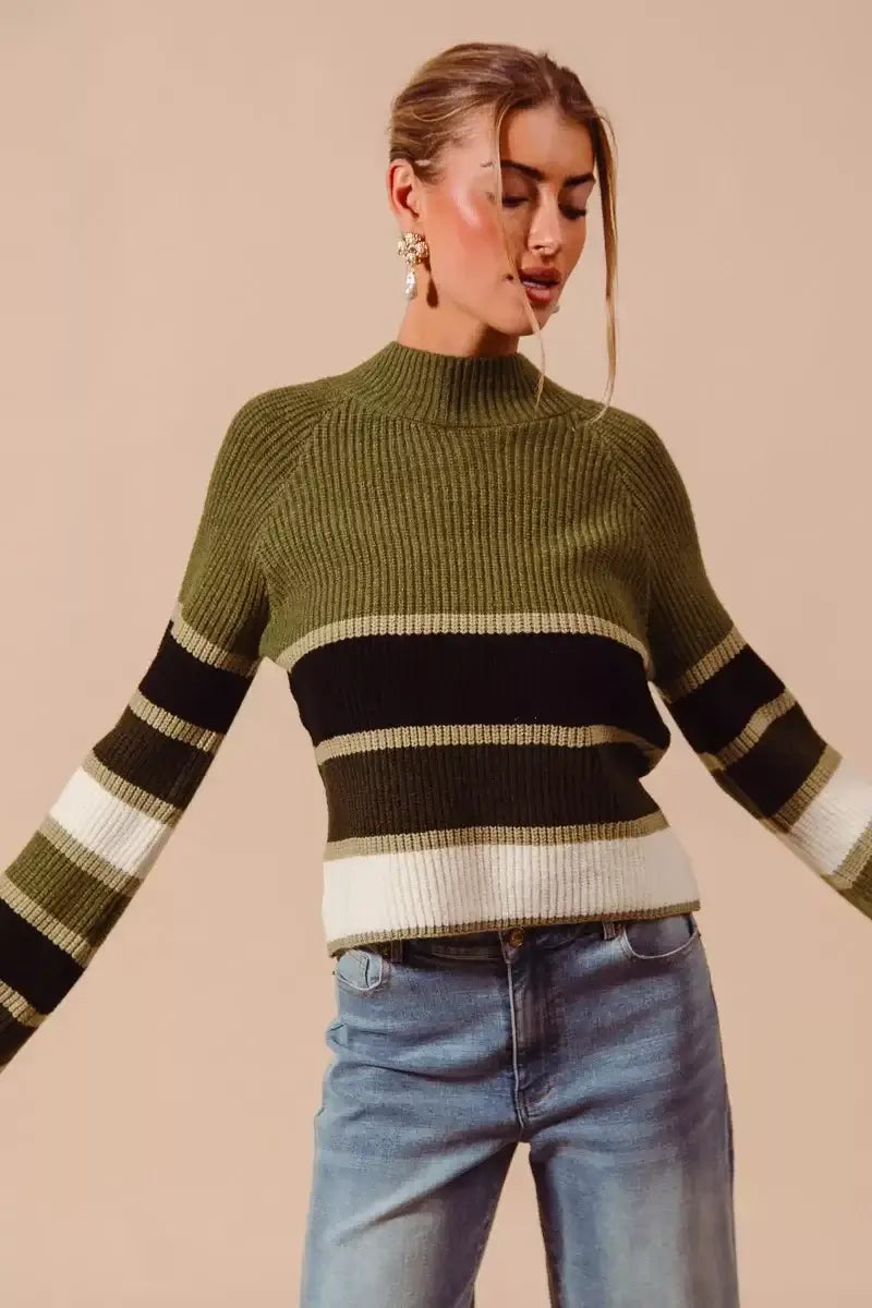 SO ME Multi Color Striped Mock Neck Sweater – Vibrant Knit in green, black, white stripes, styled with jeans.