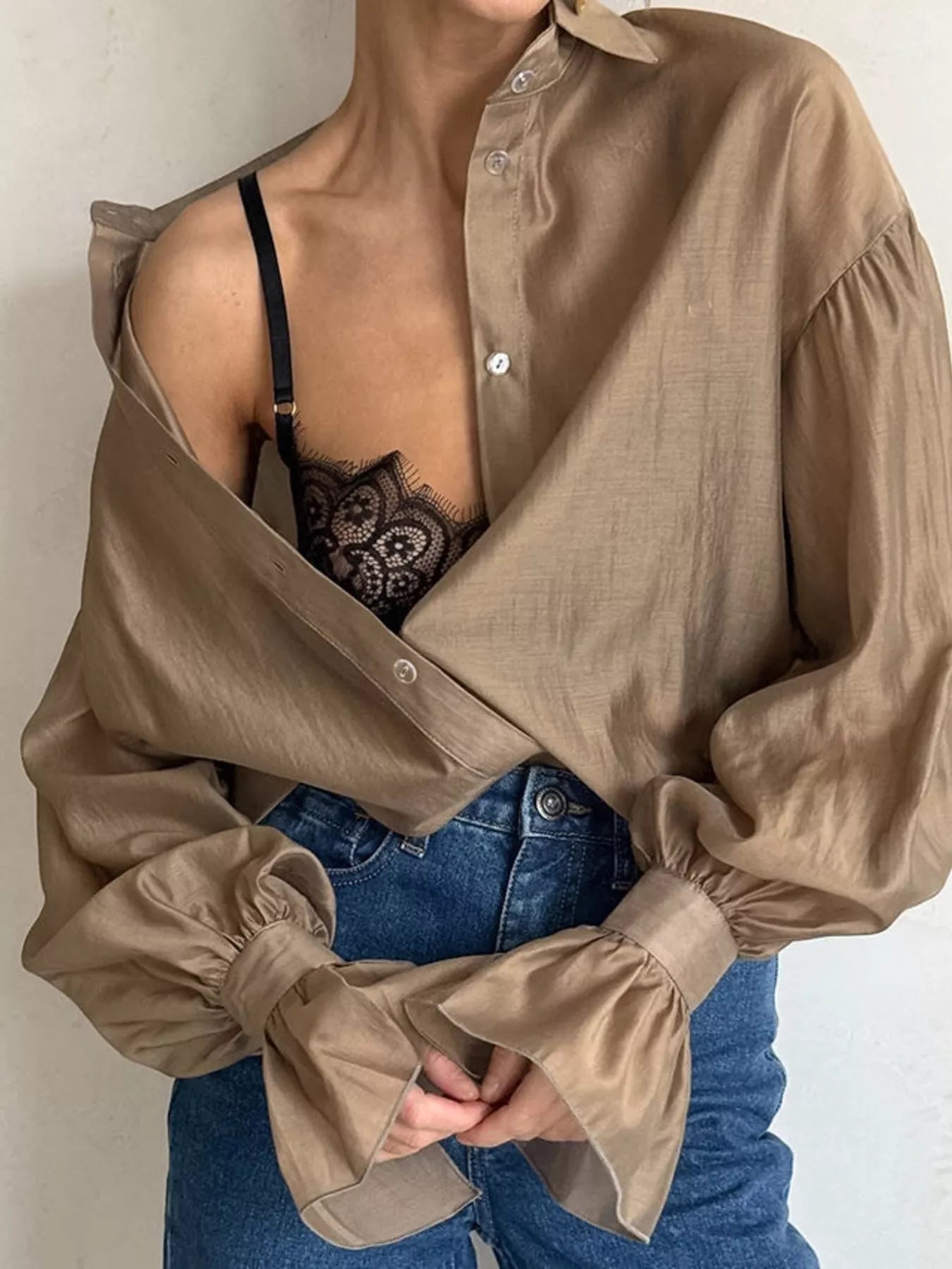 Woman wearing a Button Up Flounce Sleeve Shirt with lace bralette, featuring oversized sleeves and a stylish design.