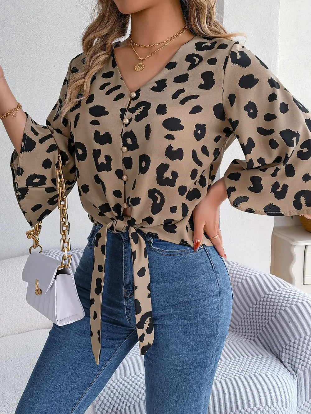 Tied Button Up Leopard V-Neck Blouse styled with jeans and accessories, showcasing a trendy animal print design.