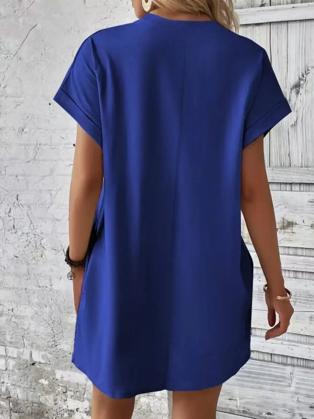 Back view of a blue Pocketed Round Neck Short Sleeve Dress, showcasing its casual style and practical pockets.