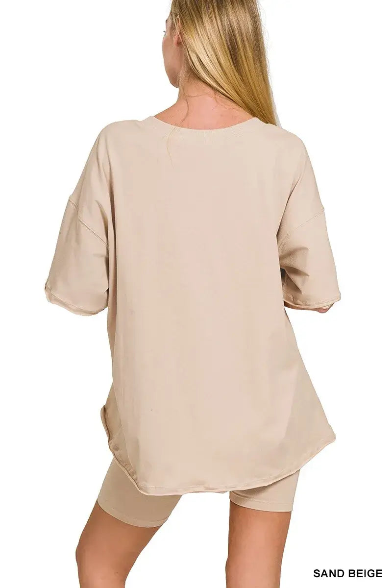 Back view of a woman wearing the Zenana Cotton V-neck Top & Biker Shorts Set in sand beige.