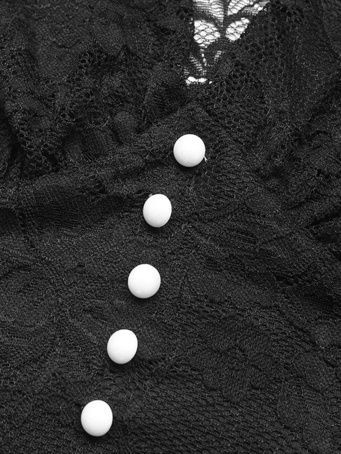 Close-up of lace long sleeve v-neck bodysuit buttons, highlighting the elegant design and delicate lace finish.