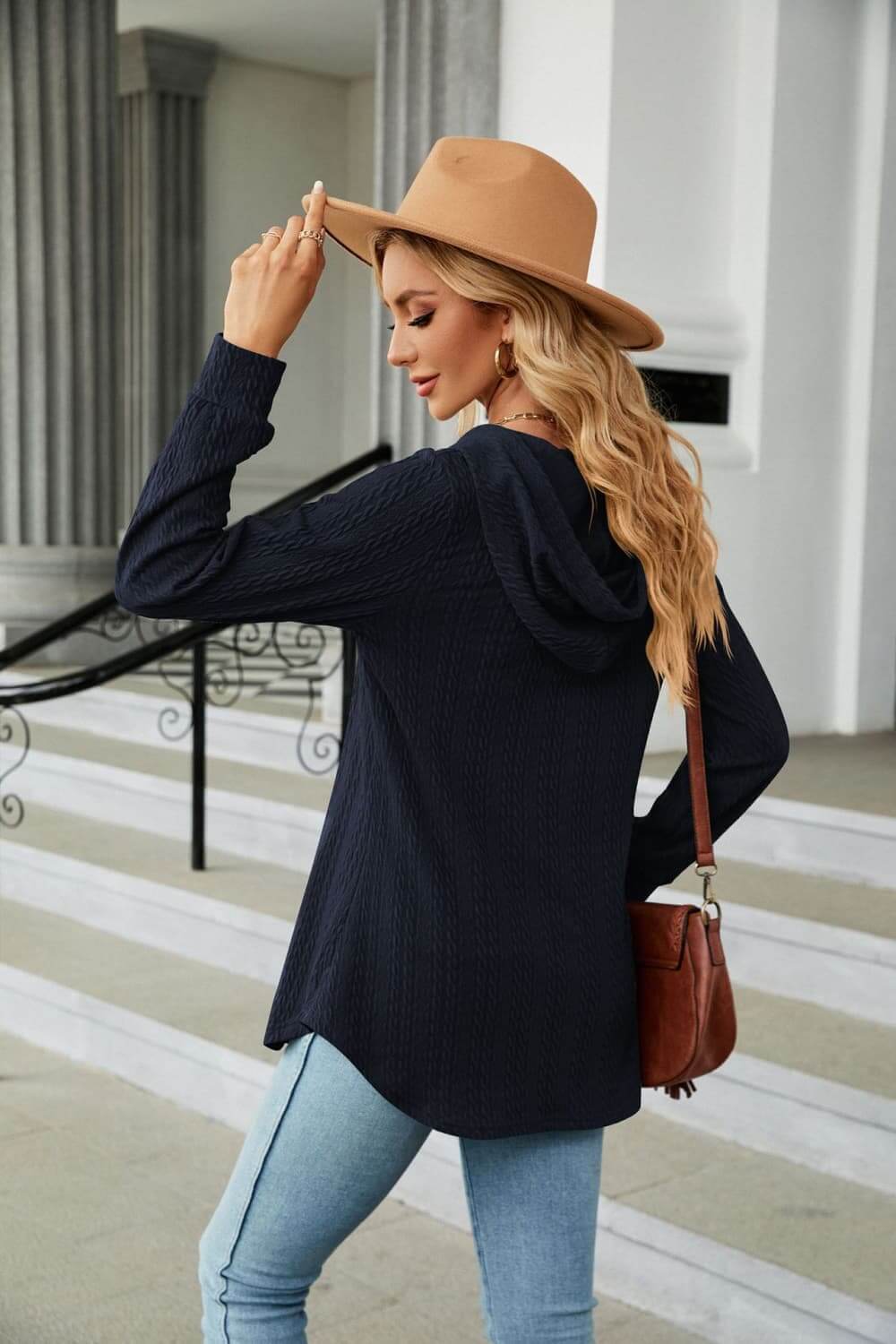 Model wearing Long Sleeve Hooded Blouse in navy blue with a drawstring hood and casual style.