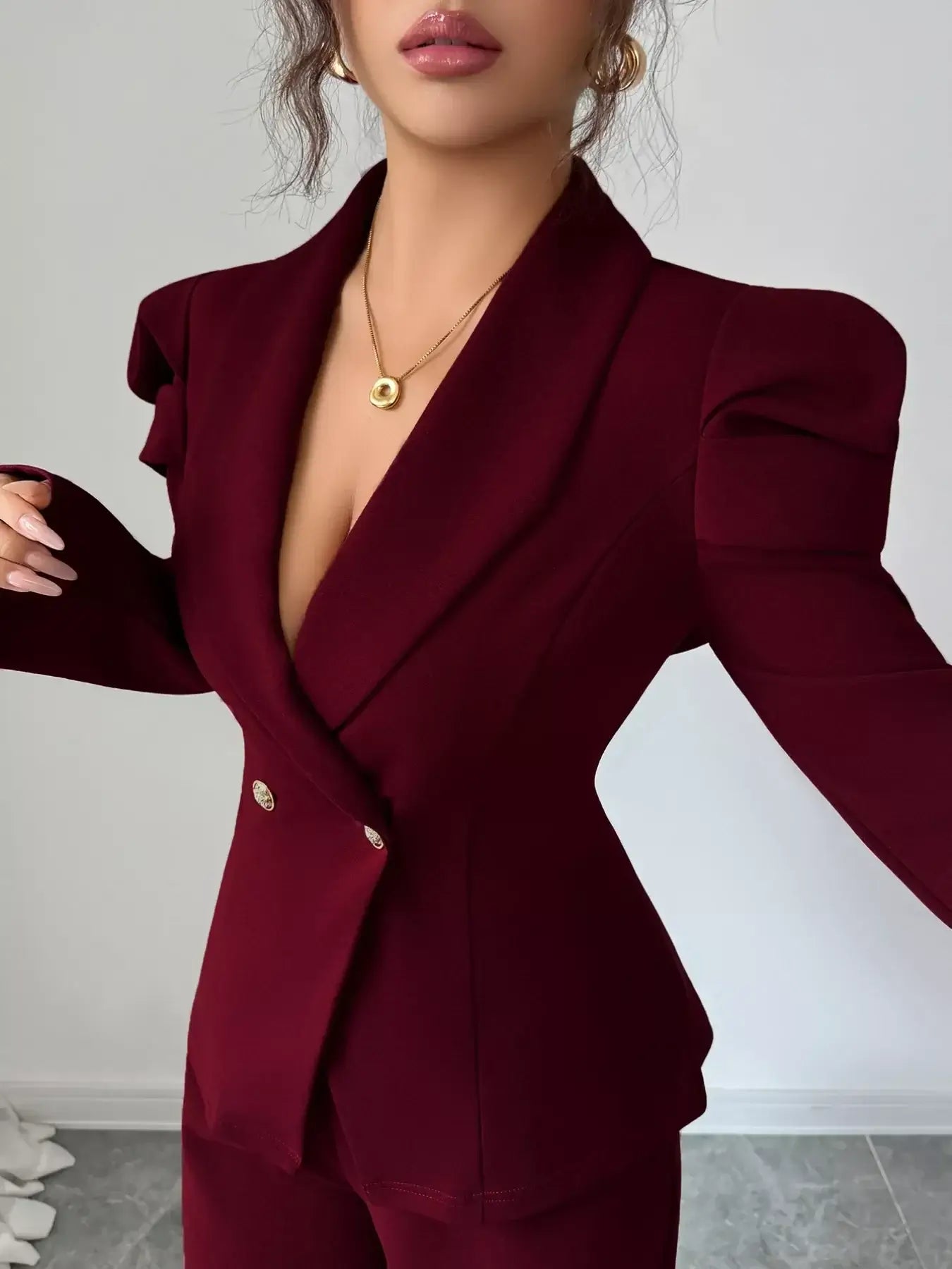 Double-Breasted Blazer and Pants Suit Set in burgundy with stylish puffy sleeves and a deep neckline.