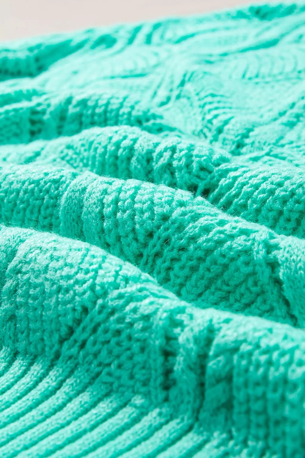 Elegant Texture V-Neck Knit Top featuring a close-up of textured cable knit pattern in vibrant teal color.