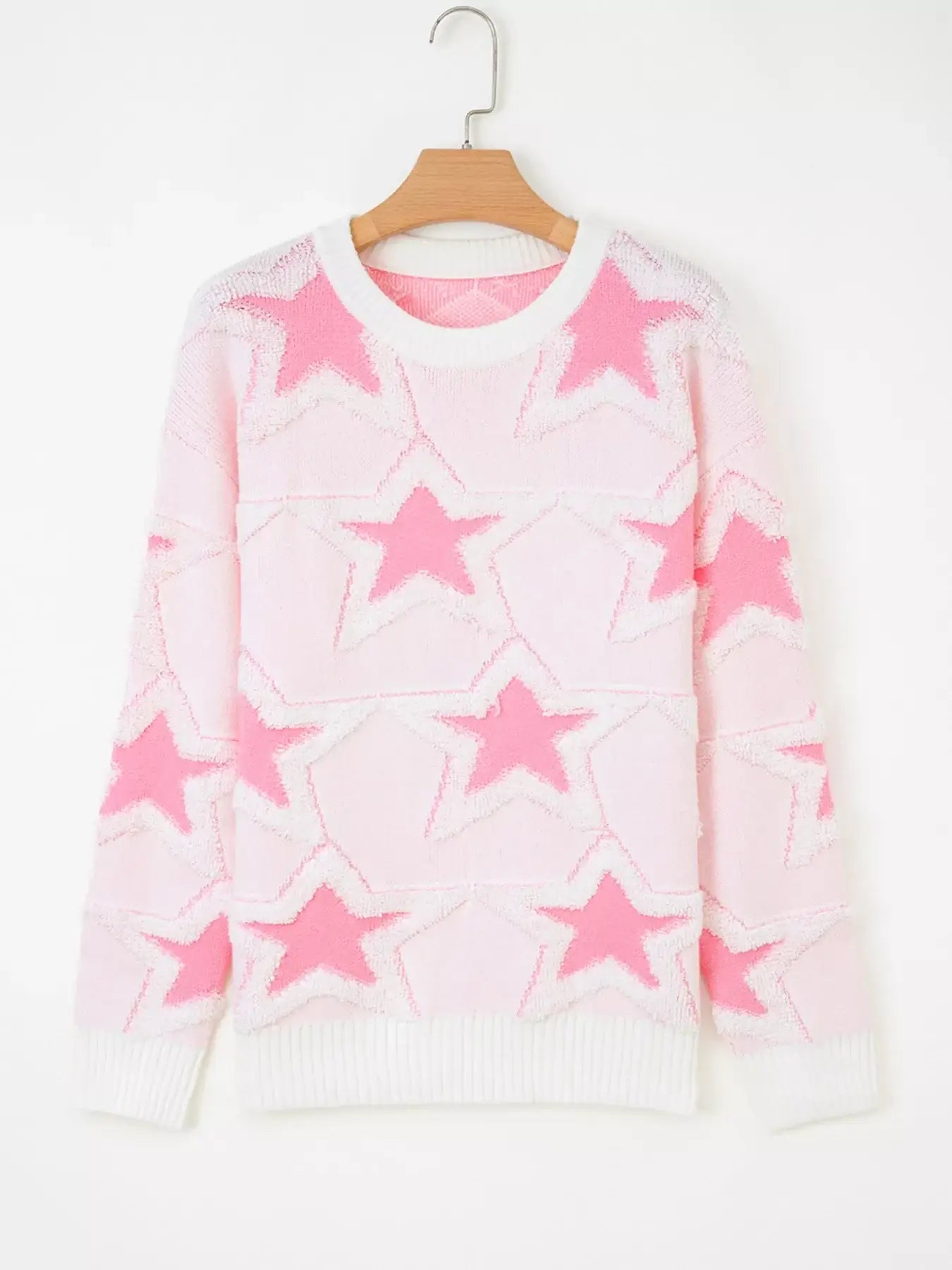 Oversized star pattern ribbed edge drop shoulder sweater in pink with star design, showcasing its cozy style.
